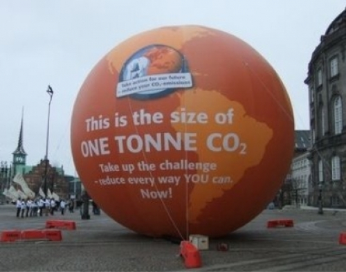 Image of a very large blow-up ball saying "this is the size of one tonne of carbon dioxide - take up the challenge, reduce every way you can Now!"