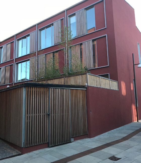 Photo showing bin and cycle storage integrated within the building envelope