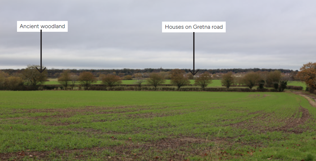 Green fields with an arrow points to the left indicating Ancient woodland, and another arrow points to the right indicating Houses on Gretna road.