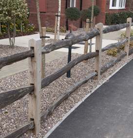 Photo of a wooden fence with a natural, organic design.